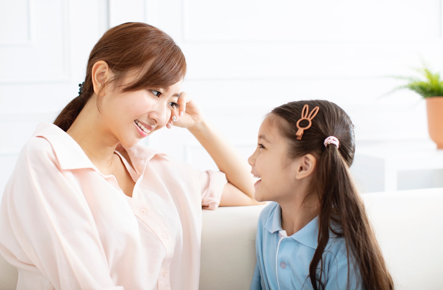 mother and daughter smiling at each other