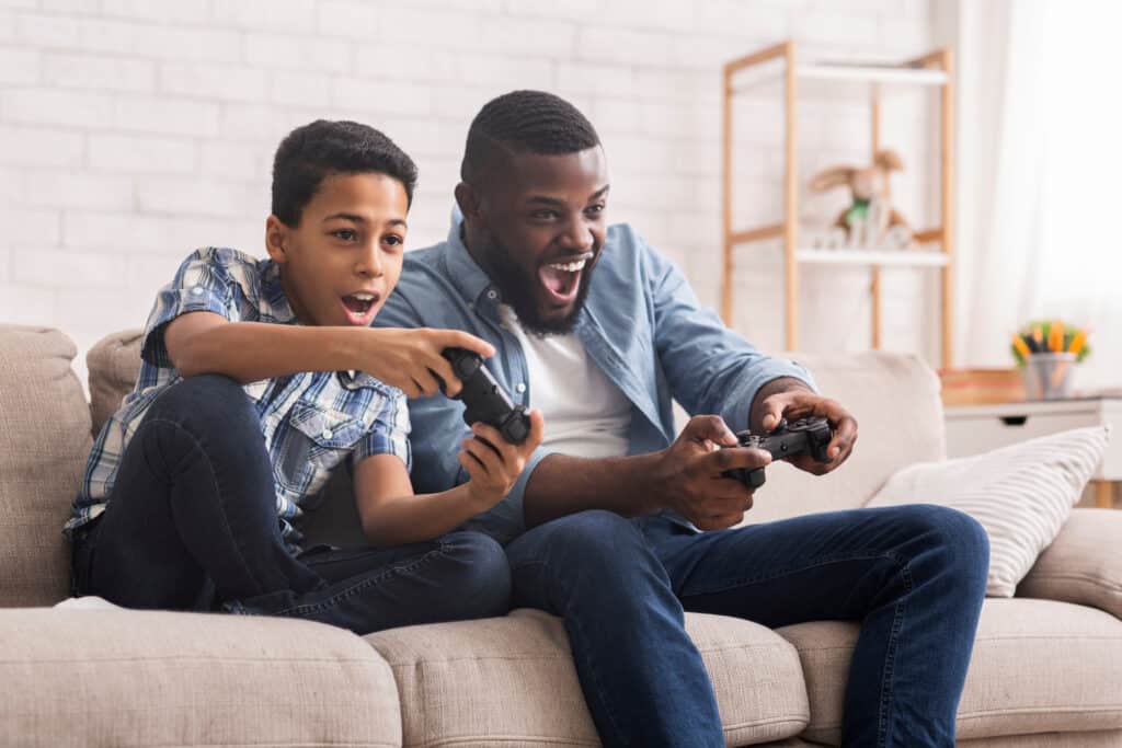 father and son playing video games together