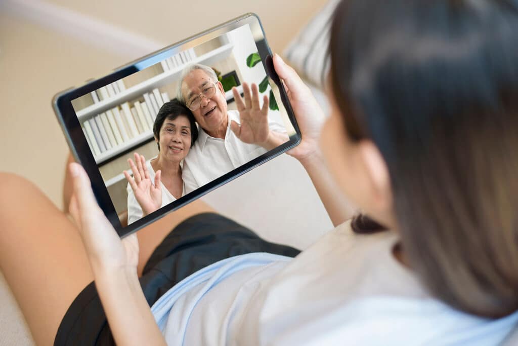 young girl video calling her grandparents