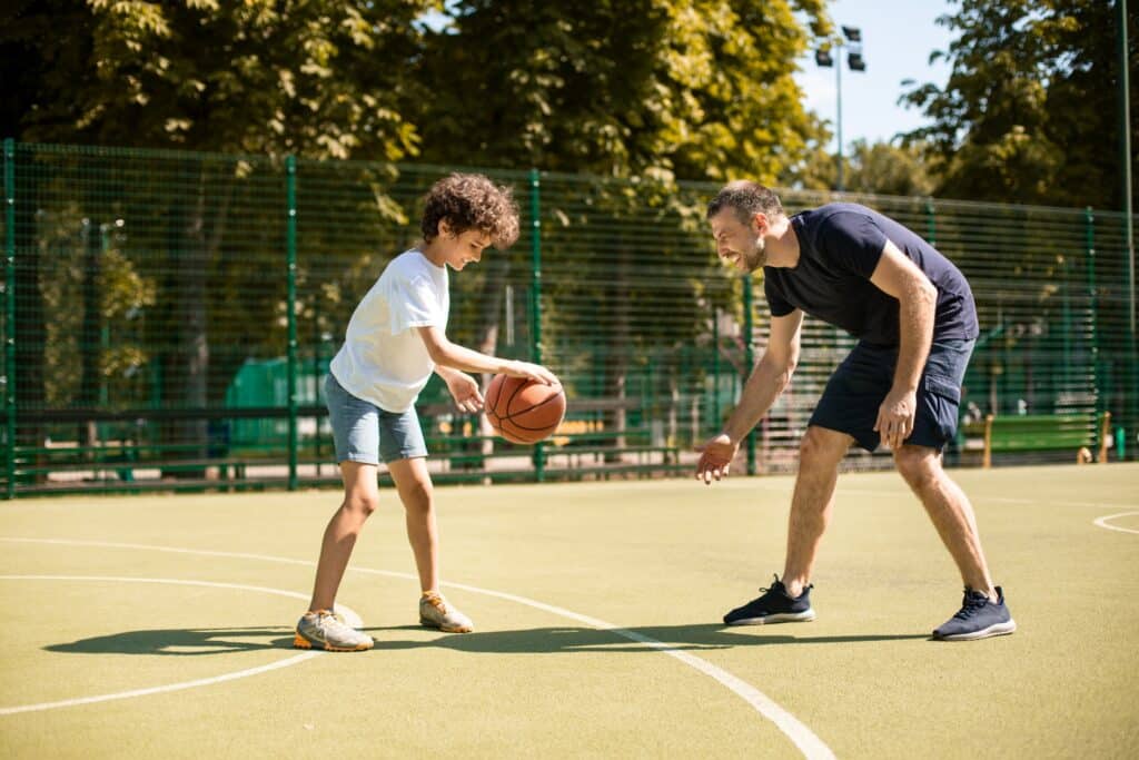 father playing basketball with his child