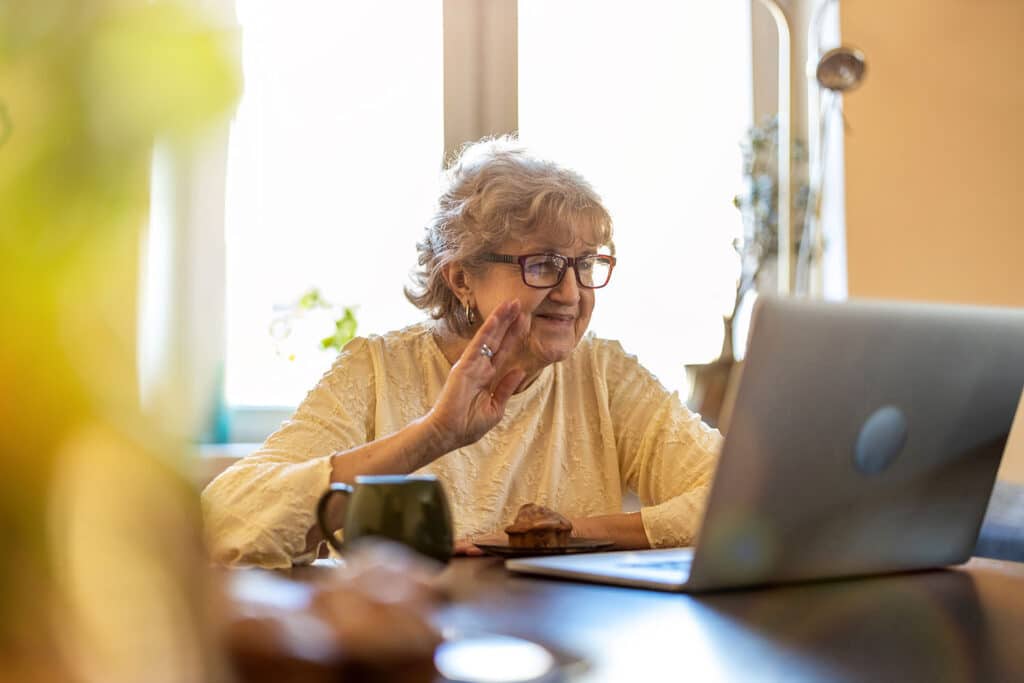 grandmother waving on a video call