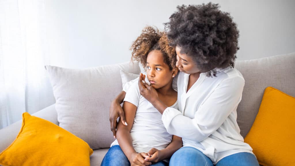 mother trying to comfort sad daughter