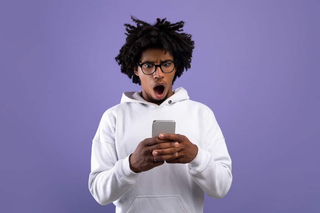 shocked man looking at cellphone