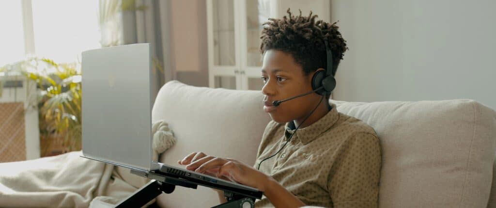 Teen boy playing video games on his laptop