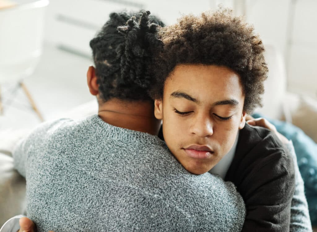 two boys hugging