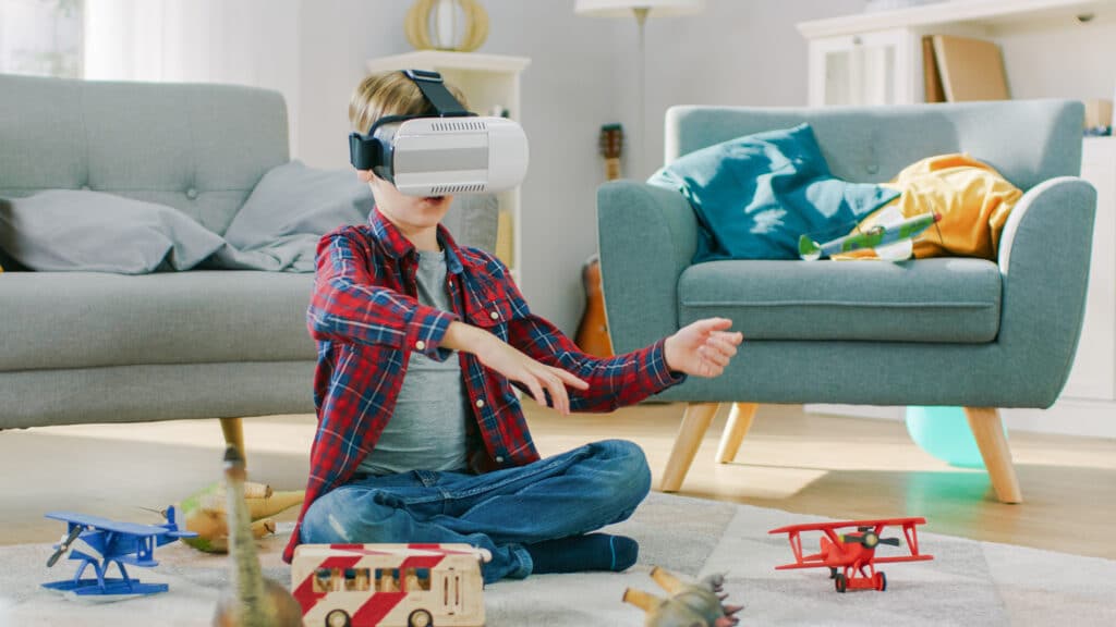 little boy on virtual reality headset surrounded by toys