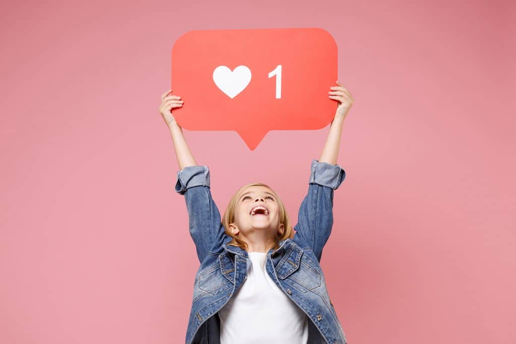 child looking up and smiling at heart notification