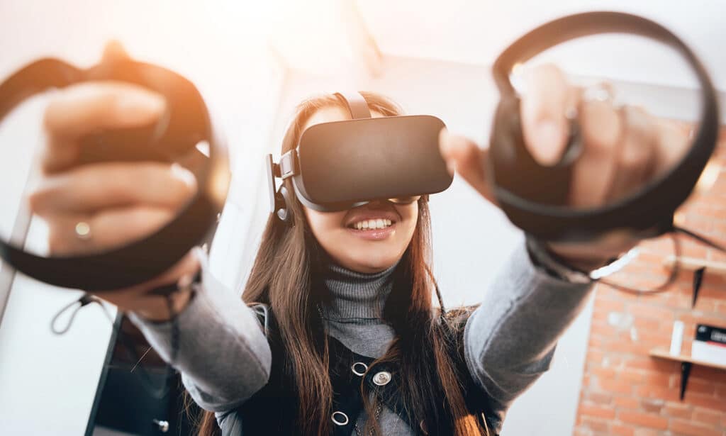 teen girl playing with oculus headset