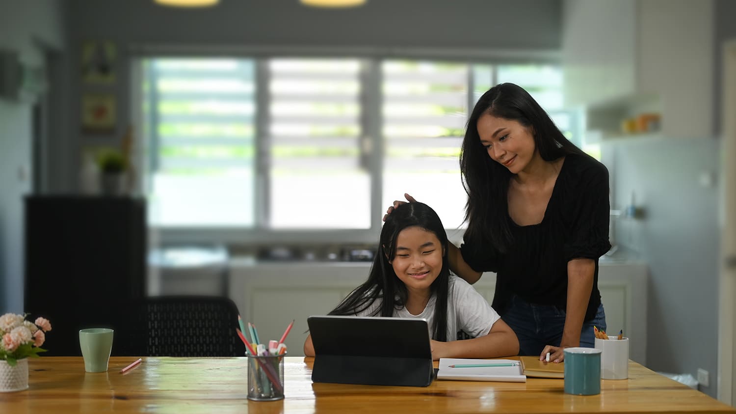 Mother helping daughter study