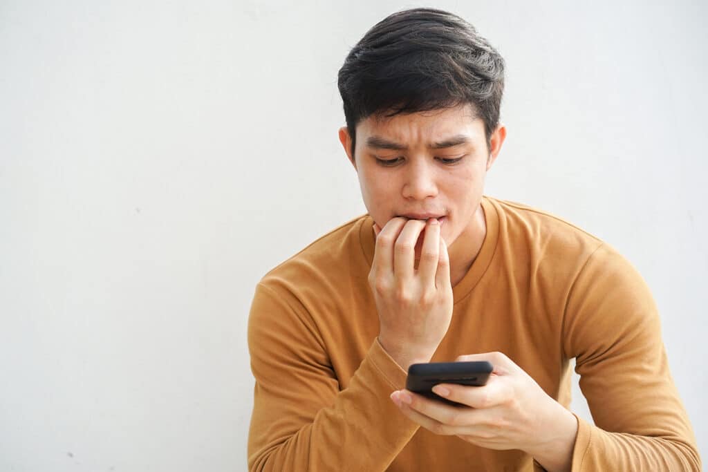 boy looking concerned at phone