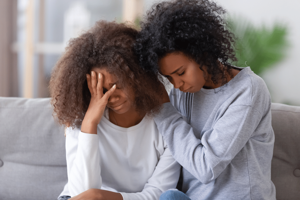 mother comforting upset daughter